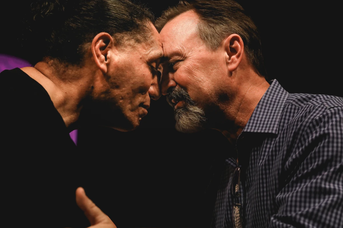 Two people sharing a hongi in greeting.